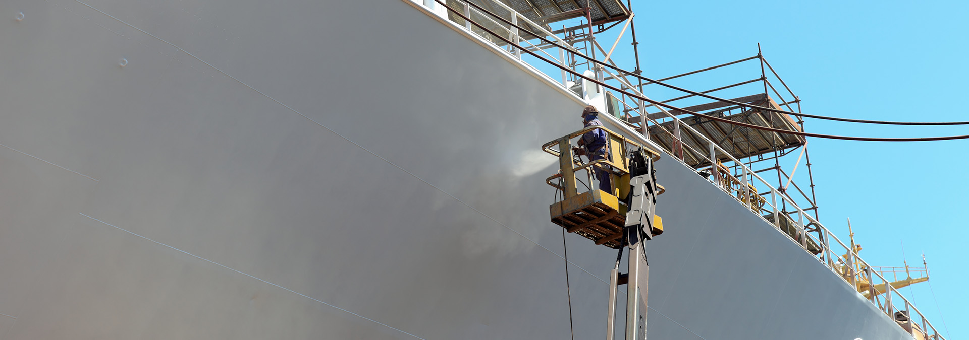 Surface treatment on a ship's side.